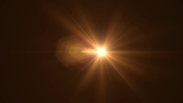 Abstract bright light burst with optical lens flare,Bright explosion of fire and light in a starry night sky with a optical lens flare.