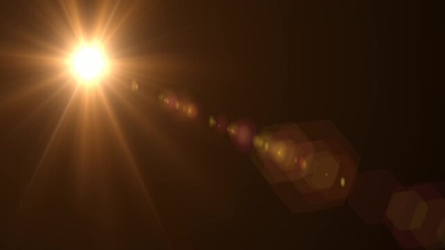 Abstract bright light burst with optical lens flare,Bright explosion of fire and light in a starry night sky with a optical lens flare.
