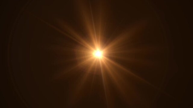 Abstract bright light burst with optical lens flare,Bright explosion of fire and light in a starry night sky with a optical lens flare.