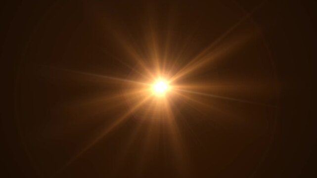Abstract bright light burst with optical lens flare,Bright explosion of fire and light in a starry night sky with a optical lens flare.