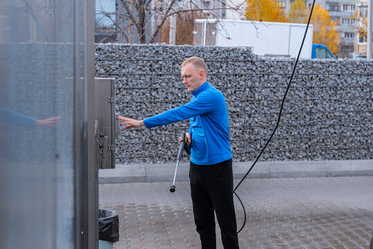 Man Washing Car at Self Service touchless Car Wash Using cashless payment terminal and professional washing equipment. The process includes paying through digital machine. Cardpayment and contactless