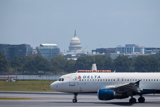 4th of July 2025, Delta Connection regional jet taking off from Ronald Reagan Washington National Airport with US Capitol backdrop. USA g.