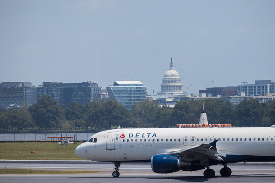 4th of July 2025, Delta Connection regional jet taking off from Ronald Reagan Washington National Airport with US Capitol backdrop. USA g.