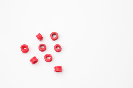 Red rubber seals for LPG gas cylinder valve isolated on white background, anti-leak silicone sealing o-rings for gas regulator.