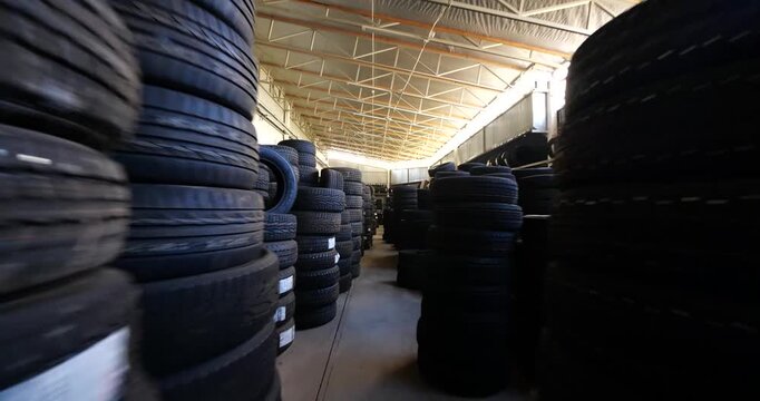 Piles of new tires in tyre warehouse for sale