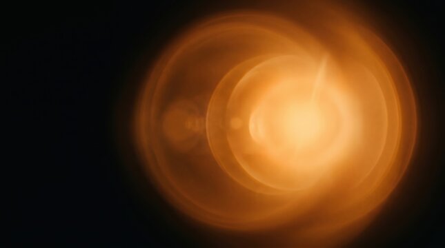 Orange lens flare overlay featuring concentric circles of amber light. High fidelity optical glow on black background for cinematic vfx and photo compositing.