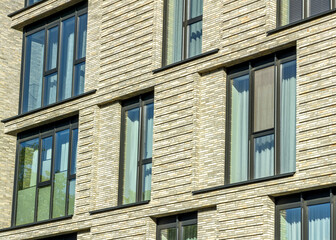Obraz premium contemporary apartment building facade with large windows.