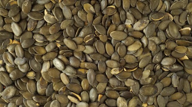 Healthy raw pumpkin seeds rotating slowly