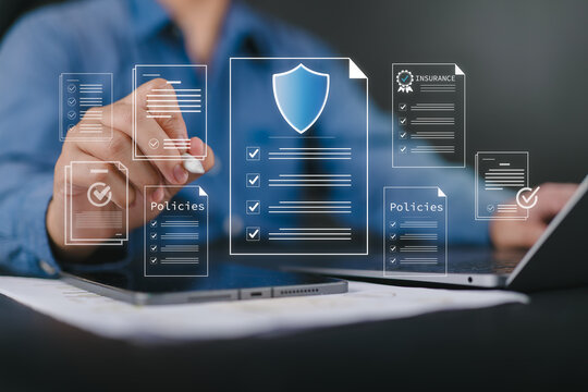 Businessman reviewing digital insurance policies and compliance documents on laptop and tablet. Risk management data security policy protection, regulatory compliance and insurance technology concept