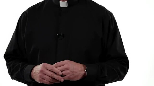 Priest in black clerical shirt with clasped hands