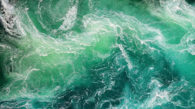 Top down view of powerful turquoise ocean whirlpools and rushing salt water currents in saltstraumen norway.