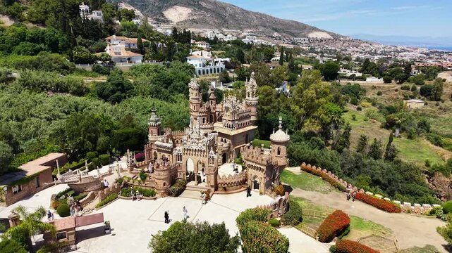Drone aerial view of Colomares Castle, an elaborate monument dedicated to Christopher Columbus, surrounded by gardens and Mediterranean landscape in Benalm&aacute;dena, M&aacute;laga, Andalusia, Spain