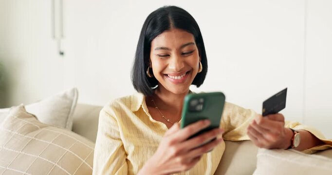 Phone, credit card and woman on sofa in home with online shopping, ecommerce or purchase on mobile app. Laugh, debit and asian person with cellphone for order on website in living room at apartment.