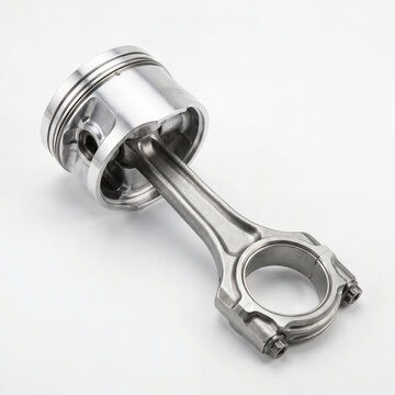 Automotive engine piston with connecting rod isolated on white background.
