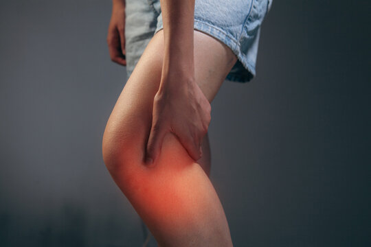 Close up of woman suffering from pain in leg,