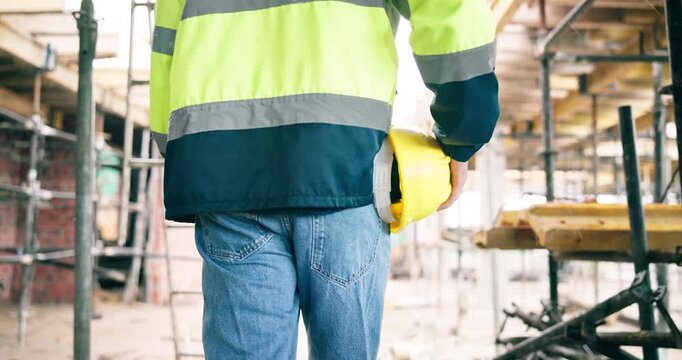 Construction, hardhat or person on site with inspection, safety check or evaluation in building project. Back, ppe or engineer with walk, progress track or quality assurance in industrial compliance.