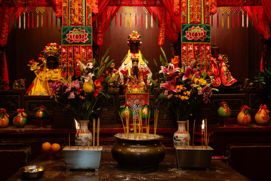 Main altar of the Kwun Yum hall at the Hung Shing Temple on Queen's Road East, Wan Chai, decorated for Chinese New Year with flowers, incense, candles, and fruit offerings