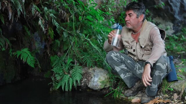 Man drinking fresh spring water from a natural mountain spring near La Garita Canyon, Sierra P&eacute;njamo, Guanajuato, Mexico.