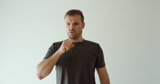 man holding his chest and covering his mouth while experiencing heartburn, acid reflux, burping, and digestive discomfort. Suitable for gastrointestinal symptoms, healthcare, stomach problems