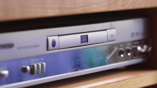 Person Pressing The Button Of A DVD Drive Disc Player. Close-up Shot