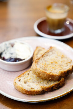 Toast sourdough bread with butter spread on a wooden table.