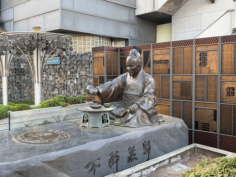Bronze Statue of Korean Historical Figure in Suwon Market - Realistic photo of seated traditional scholar statue with table and inscriptions. Ideal for history, culture, landmark, and tourism concepts