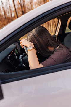 Woman experiencing stress and exhaustion driving car