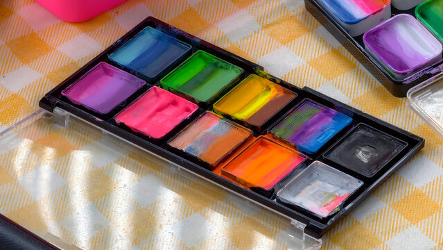 A colorful palette of professional face paint colors, perfect for creative makeup artists and vibrant artistic expressions on skin