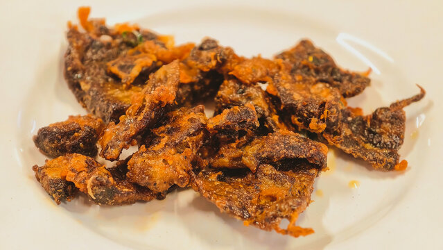 Indonesian Crispy Fried Beef Lung served on a White Plate, Traditional Paru Goreng Dish