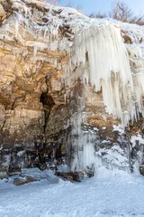 Large icicles hang from the steep cliffs. © sv_production