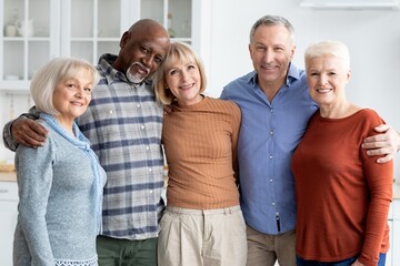 Obraz premium Happy Multiracial Senior Group Of Four Adults Smiling Together In Home Environment, Enjoying Each Other's Company And Sharing Moments Of Joy, Indoor Setting Reflecting Community Concept.