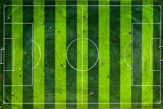 Aerial top view of soccer field with players executing team strategy for athletic training and sports corporate marketing