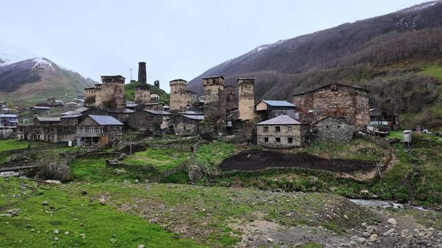 Ancient Svaneti stone defensive towers in Ushguli village, Georgia, historic mountain landscape, remote highland architecture, travel exploration
