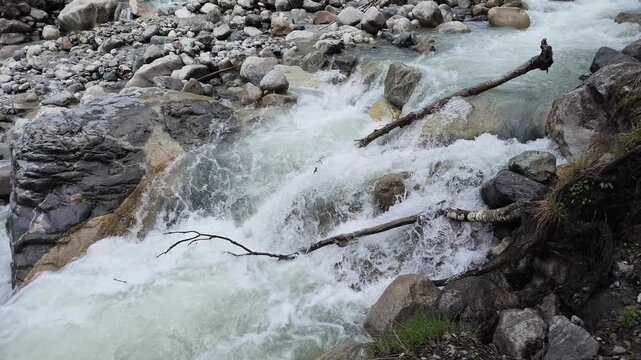 Fast mountain stream flowing over rocks in Svaneti, splashing whitewater and rapid currents in wilderness nature, refreshing outdoor scenery