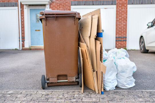 Household rubbish, cardboard and recycling bin outside a suburban property illustrating waste disposal and recycling challenges