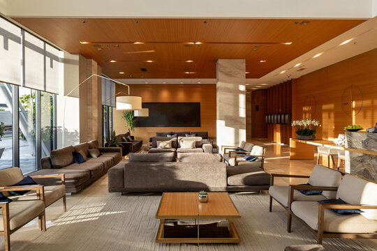 Luxury hotel lobby lounge area with comfortable sofas and warm lighting