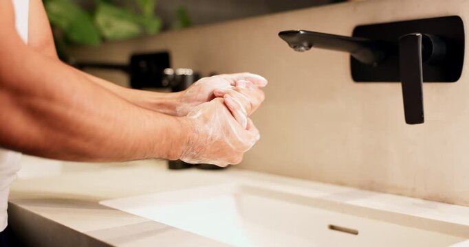 Sink, soap, washing hands with man in bathroom of home for disinfection or hygiene. Basin, cleaning and foam with person in apartment to remove bacteria or germs for morning self care routine