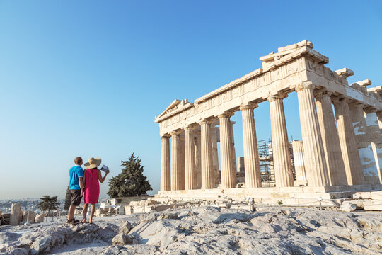 Couple looking at the famous Parthenon temple on the Acropolis, Athens, Greece