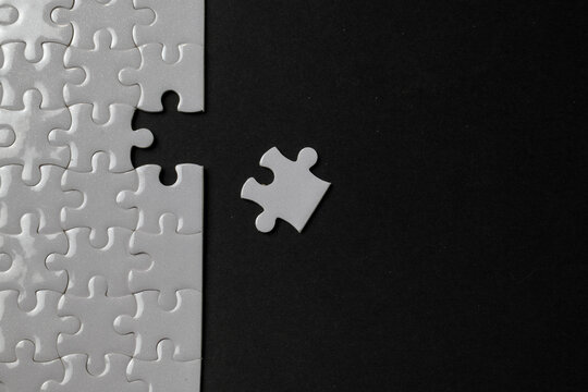 Missing puzzle piece concept on black background