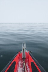 Red expedition boat approaching sea ice in the Arctic Ocean, Svalbard © Sjoerd