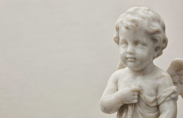 Obraz premium White Marble Cherub Angel Child Statue Close-Up Portrait with Wings on Light Gray Background