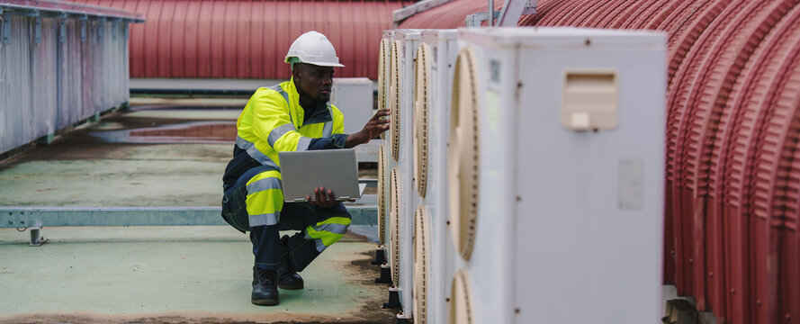 Technicians are inspecting the air conditioning and refrigeration systems in a commercial building.	