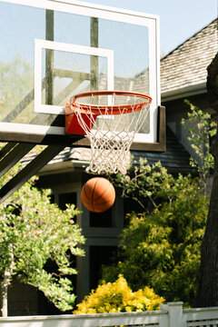 Basketball shot swishes through the net outdoors
