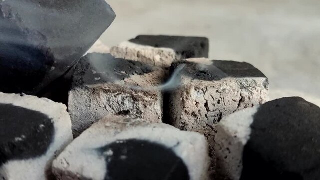 Burning charcoal briquettes with white ash. Made from renewable biomass waste and produces little ash