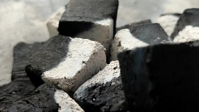 Burning charcoal briquettes with white ash. Made from renewable biomass waste and produces little ash