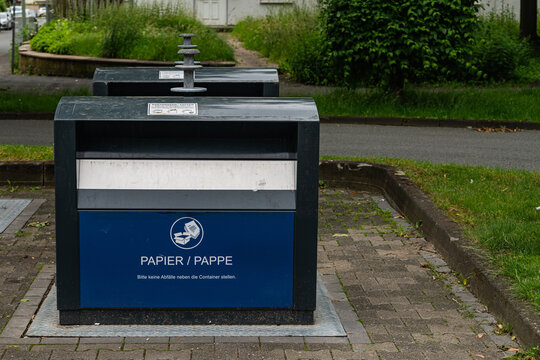Waste bins for paper recycling in a city park area