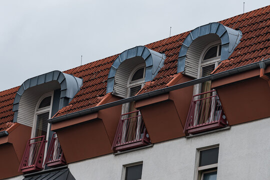 Roof design with unique windows and balconies in a city