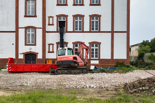 Construction site with excavator at a building in progress
