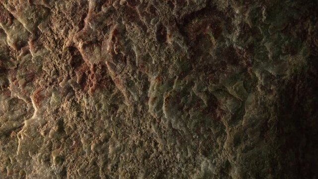Moving sunlight across weathered stone surface