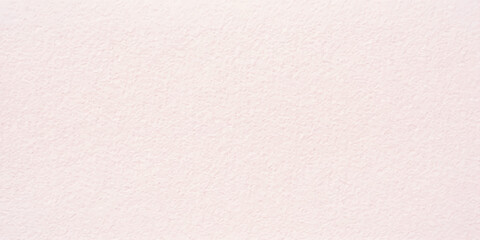 Fototapeta premium A textured light pink paper surface, showing a subtle grain and soft, organic feel, perfect for artistic or design use.